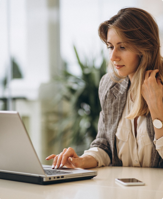 Professional businesswoman at desk using laptop